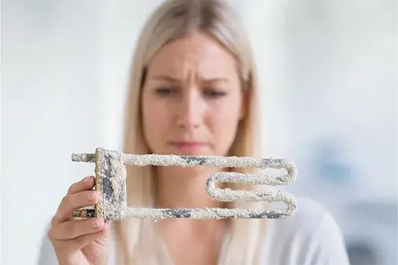 Washing machine heating element with limescale deposits (Before SoluCalc)